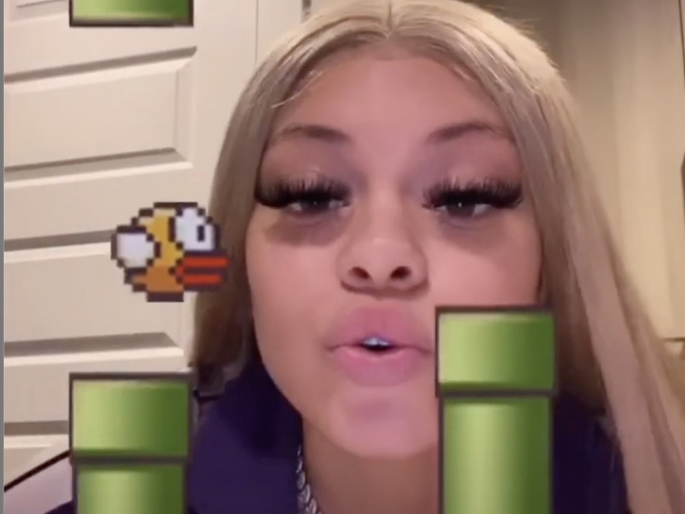 Mulatto Proves Her Head Shakes Pay Off Playing Mobile Bird Game
