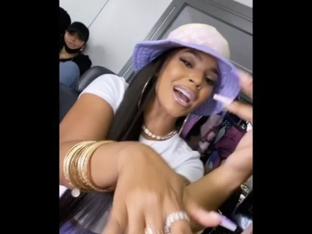 Ashanti’s Purple Booty Shorts and Bucket Hat Have Her Flexing Barney Vibes